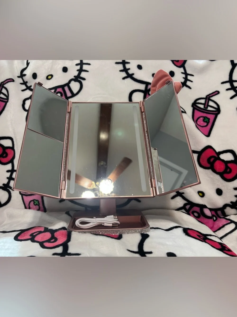 Pink trifold makeup mirror with lights
